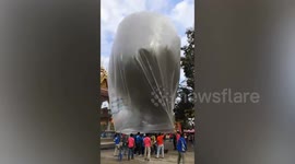 Gigantic 50ft-tall baloney-shaped balloon flies at Thai lantern festival