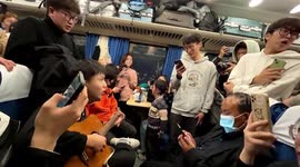 Dozens of strangers sing together during long-distance train journey in China