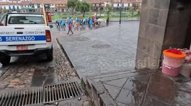 Peaceful protesters marching in la Plaza de Armas of Cusco, Peru during a rainstorm.