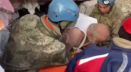 Turkish survivor is pulled out from rubble with cigarette in his mouth and refuses to drop it