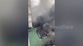 Dark smoke swells from building as blaze rips through bus terminal in the Philippines