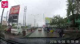 Dashcam footage shows motorcycle accident due to slippery road.