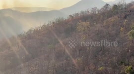 Helicopter tackles mountain fire in northern Thailand