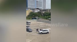 Crazed husband clings to wife's car windshield as he demands his money back