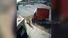 Biker has incredibly narrow escape after speeding truck crashes into bike