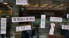 Conspiracy theorists cover London's ITV building with stickers reading 'the media is the virus'