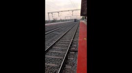 Indian train passes through station . Express train pass through at a Station