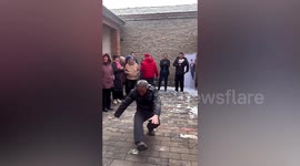 Elderly man performs freestyle breakdance to entertain guests at wedding ceremony
