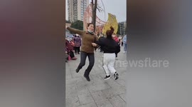 Skilful Chinese residents dance while playing double Dutch
