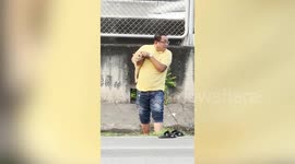 Kind driver rescues helpless tabby cat trapped in roadside drain