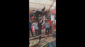 Street circus performer from Vietnam lifts motorbike and man