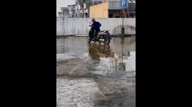 A group of friends stumble and fall on a slippery road in Indonesia
