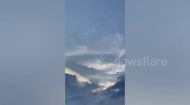 Spectacular iridescent clouds form during sunset in the Philippines