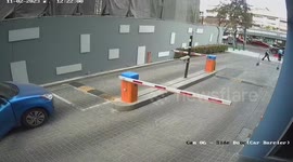 Bungling driver muddles up his automatic gears and crashes through car park barrier