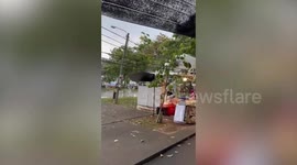 Frantic shoppers seek shelter as rain hits market in Bangkok
