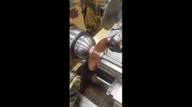 Satisfying footage shows smith transport copper disc into light fitting