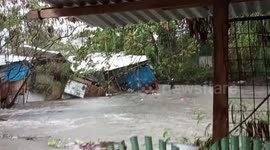 Family cry as their home is washed away by floods in the Philippines