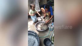 Little girl cries hysterically when father butchers fish from market
