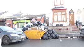 Residents fury at living on 'disgusting' residential road which is infested with rats after mountain of rubbish was dumped into overflowing skip