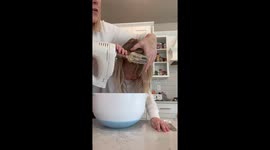 Oh no! Little girl gets her hair stuck in beaters while baking storm with her mom