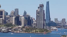 Unique video of SailGP DENMARK super yacht sailing across Sydney harbour and panoramic city background .