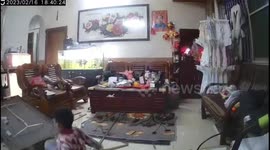 Ceiling light narrowly misses boy sitting in his living room in China