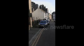 Locals inspect Banksy's latest artwork in Margate after freezer was removed
