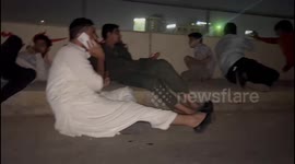 Journalists take cover on bridge as gunmen attack police compound in Karachi, Pakistan