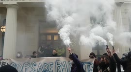 Women's Rights protesters activate rape alarms and smoke flares outside Charing Cross Police Station