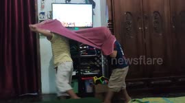 Watching video then kids perfom Barongsai dance using towel in Batusangkar, West Sumatra, Indonesia, on February 19, 2023.