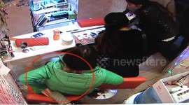 Woman sneaks wallet in her coat from chair behind
