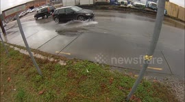 Cars drive through New Orleans flooding
