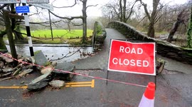 Floodwater destroys Cumbria bridges