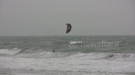 Windsurfers enjoy stormy UK coast