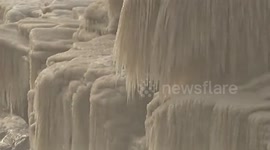 Frost and ice covers Hukou Falls at Yellow River