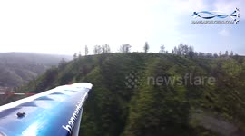 Pilot fly under the cliff