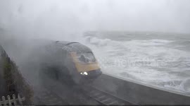 Coastal waves from Storm Frank obscure train windscreen