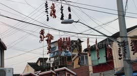 Shanghai foodies hang sausages and bacon on wires in preparation for Spring Festival