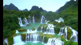 Beautiful drone footage of water rushing off Detian waterfall
