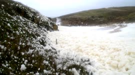 Sea foam deluge on Brittany sea shore