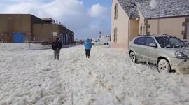 Struggling through sea foam blizzard in France