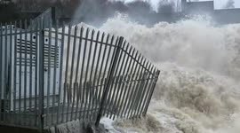Powerful floodwater rushes over dam in Scotland