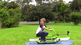 Dad makes mowing the lawn more fun for his kids