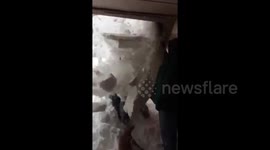 Moment kids buried under snow from rooftop