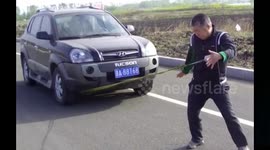 Kung fu doctor uses one hand to pull a car