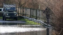 Man Checks Water Level Before Driving Through Floods