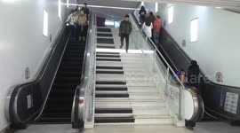 People play piano by walking down the stairs at a subway station
