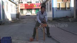 Martial artist smashes bricks and beer bottler with his hands