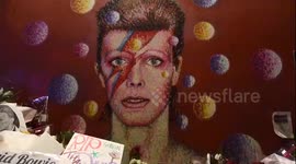 Fans in Brixton, London play tribute to David Bowie