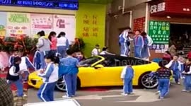 Pupils play wildly on Porsche 911 parking at roadside